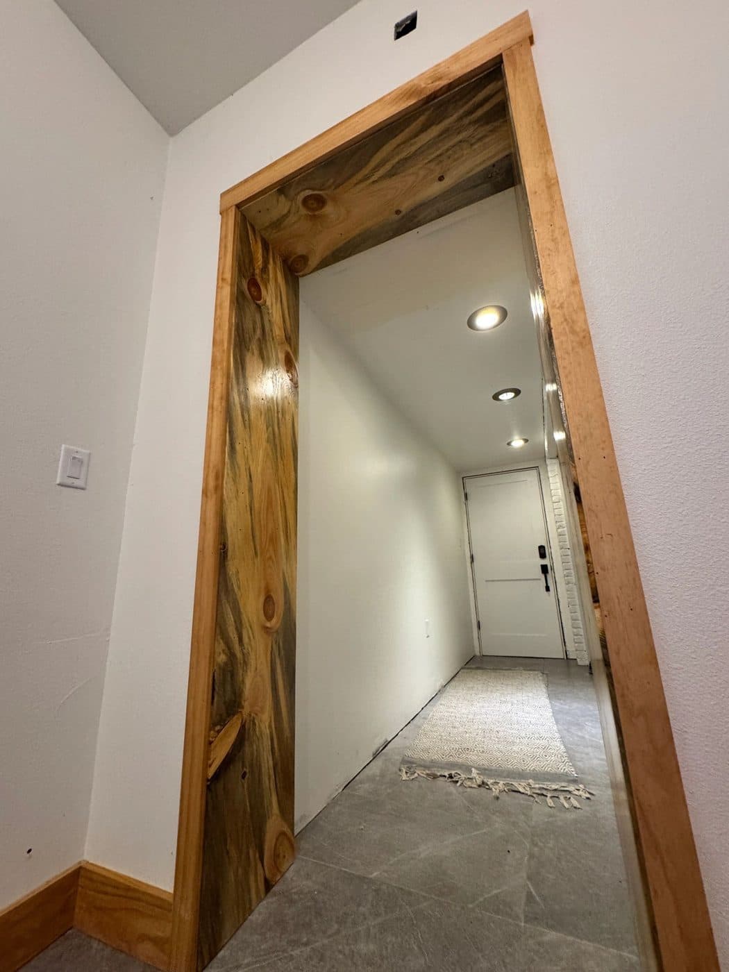 A hallway doorway cased in blue-streaked beetle-kill pine